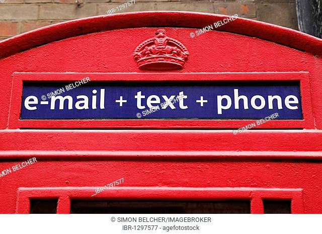 Traditional red telephone box offering e-mail, text and phone services, United Kingdom, Europe