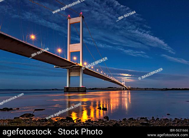 View of road bridge and rising full moon, Severn Bridge (First Severn Crossing), River Severn, Severn Estuary, Monmouthshire, Wales, United Kingdom, Europe