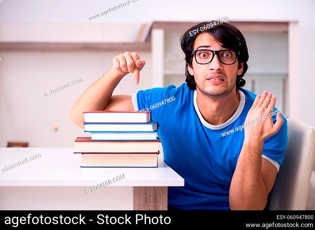 Young handsome student studying at home