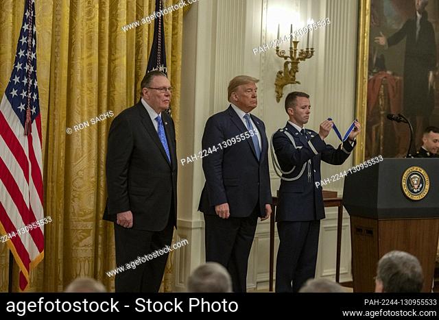 United States President Donald J. Trump, center, listens to the citation as he presents the Presidential Medal of Freedom to US Army General John M