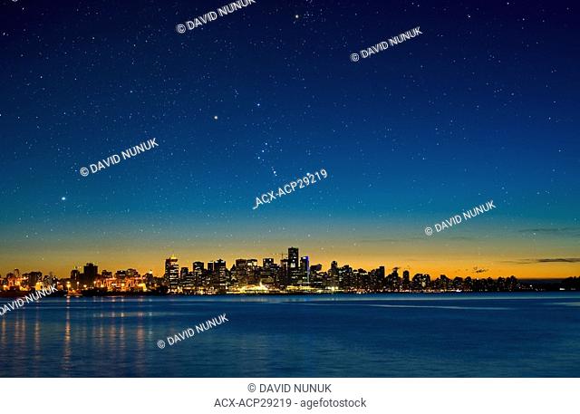 The constellation Orion setting over Vancouver skyline