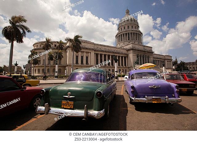 Old American cars used as taxi at the parking lot in front of the Capitolio building in Central Havana, Cuba, West Indies, Central America