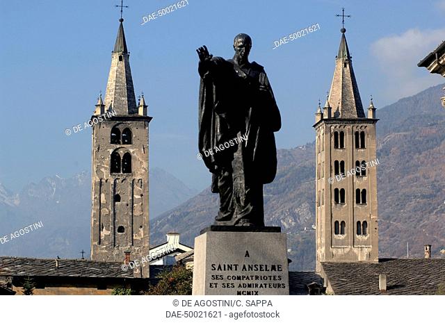 The Romanesque bell towers of Aosta cathedral and the statue of Saint Anselm of Aosta, or St Anselm of Canterbury (1033 or 1034-1109), Aosta, Valle d' Aosta
