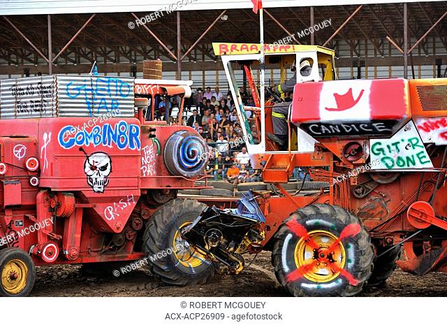 Two combine harvesters do battle in a farm equipment demolition derby in rural Alberta Canada