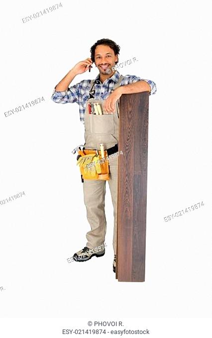 Man with laminate flooring and cellphone
