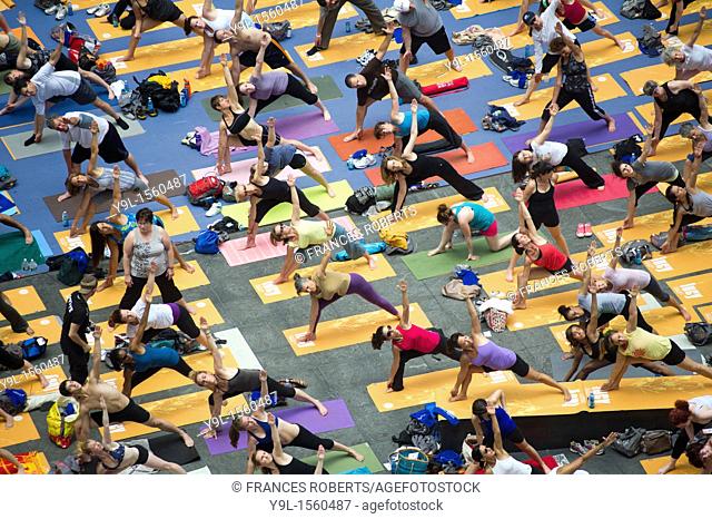 Thousands of yoga practitioners in Times Square in New York participate in a group Bikram Yoga class observing the Summer Solstice at 1:16 PM  The classes given...