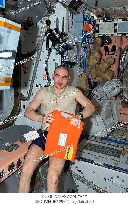 Russian cosmonaut Anatoly Ivanishin, Expedition 30 flight engineer, holds an ammonia respirator kit in the Unity node of the International Space Station