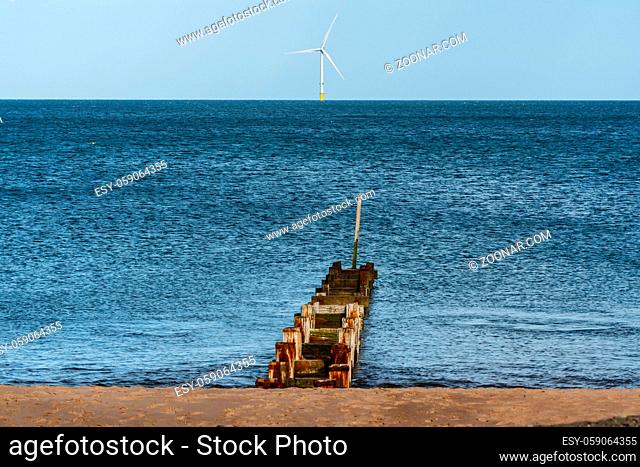 North Sea Coast near Seaton Sluice in Northumberland, England, UK - with a wind turbine in the background