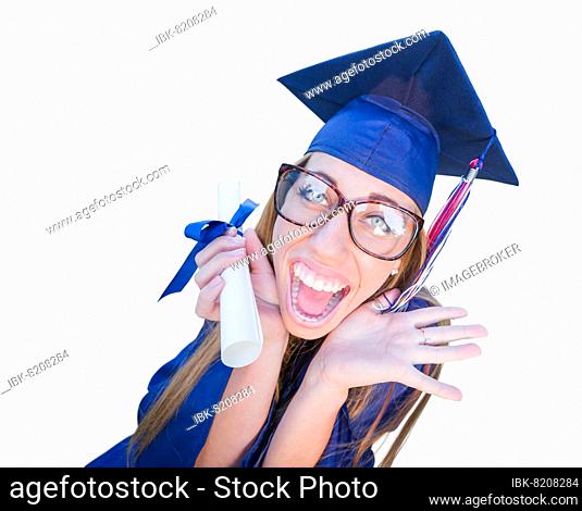 Goofy graduating young girl in cap and gown isolated on a white background