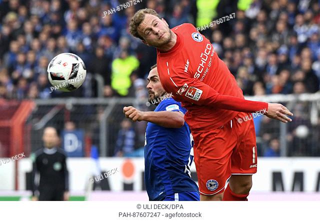Karlsruhe's Erwin Hoffer (l) and Bielefeld's Christoph Hemlein in action during the 2nd Bundesliga soccer match between Karlsruher SC and Arminia Bielefeld at...