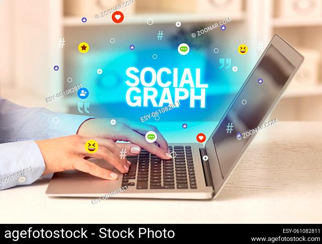 Freelance woman using laptop with SOCIAL GRAPH inscription, Social media concept