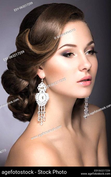 Portrait of a beautiful woman in the image of the bride with jewelry in her hair. Picture taken in the studio on a black background