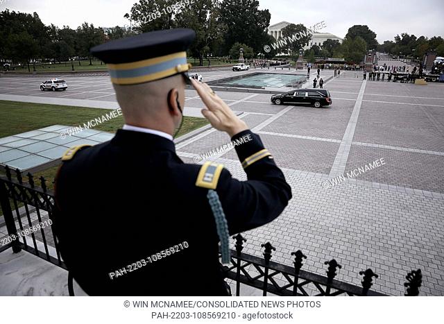 WASHINGTON, DC - SEPTEMBER 01: A member of a military honor guard team salutes as a hearse carrying the casket of the late-Sen