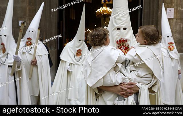 14 April 2022, Spain, Palma: The Young Penitents Teresa and Rita are carried by their mother in the procession of the saint figure ""Crist de la sang""