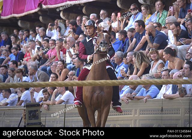 Jockeys compete at the historical horse race Palio di Siena 2022 on August 17, 2022 in Siena, Italy. - rome/Rome/