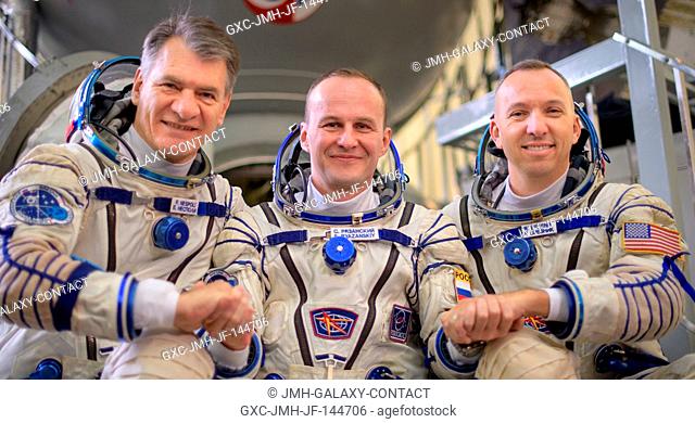 Expedition 52 flight engineers Paolo Nespoli of ESA, left, Sergey Ryazanskiy of Roscosmos, and Randy Bresnik of NASA pose for a photograph outside the Soyuz...