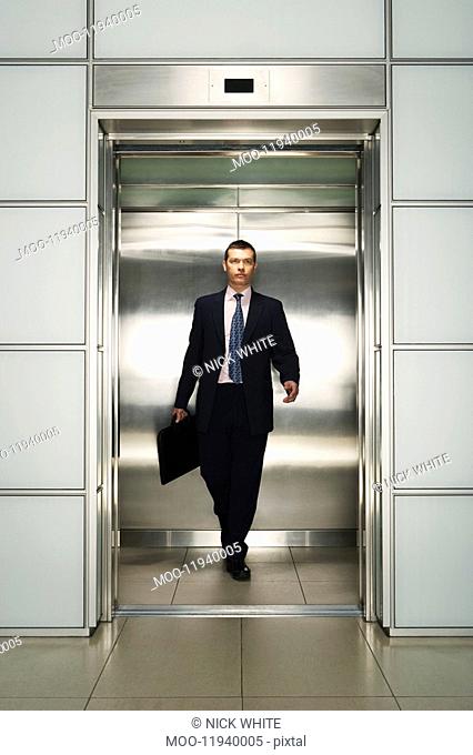 Businessman Exiting Elevator front view