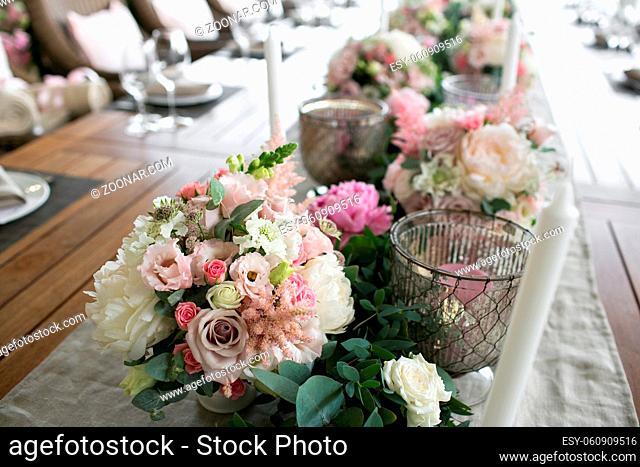 Luxury, elegant wedding reception table arrangement, floral centerpiece. Professional work florists. Decoration family dinner