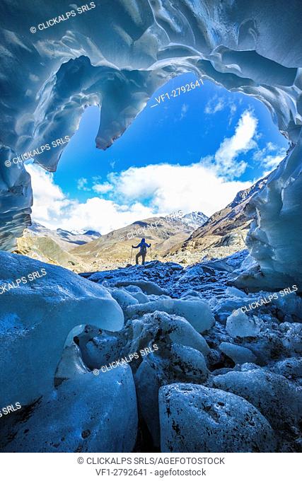 Hiker inside Forni Glacier Forni Valley Stelvio National Park Valfurva Valtellina Lombardy Italy Europe
