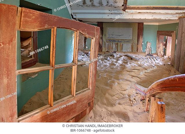 Interior of house ruins filled with sand in Kolmanskop, Namibia, Africa