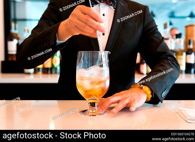 Bartender Stirring a Drink on the Counter Fancy Tuxedo High Scale Restaurant