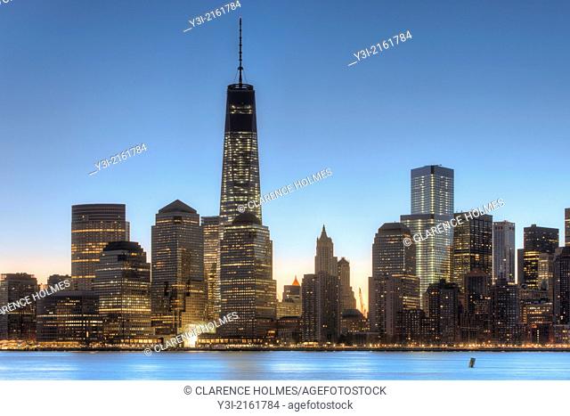 The Freedom Tower 1 World Trade Center and other buildings of the lower Manhattan skyline are illuminated as the sky brightens shortly before sunrise in New...
