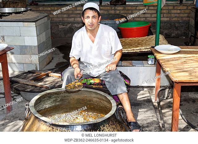 Man cooking plov, typical traditional Uzbek food, Navoi Province, Uzbekistan