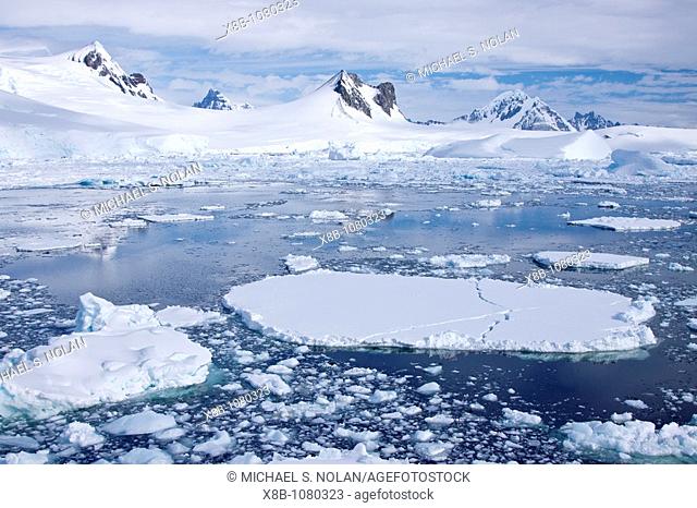 The Lindblad Expeditions ship National Geographic Explorer pushes through ice in Crystal Sound, south of the Antarctic Circle, Antarctica