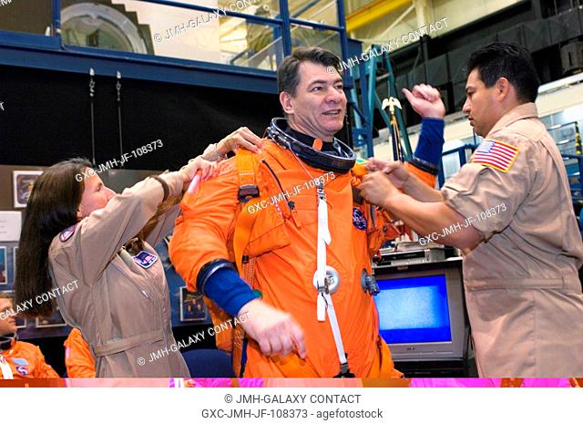 European Space Agency (ESA) astronaut Paolo Nespoli, STS-120 mission specialist, dons a training version of his shuttle launch and entry suit in preparation for...