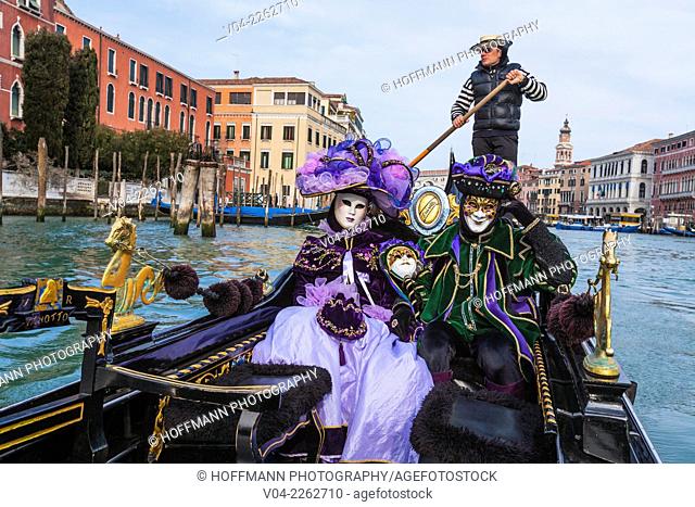 A masked couple in a gondola on the Grand Canal (Canale Grande) at the carnival in Venice, Italy, Europe