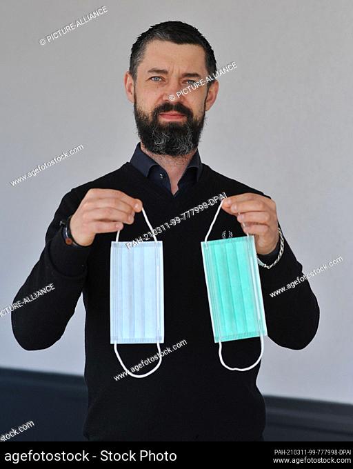 03 March 2021, Berlin, Marzahn: Nico Feichtinger, CEO of Typ IIR GmbH, presents the three-layer surgical masks produced at his plant in Berlin-Marzahn on 3...