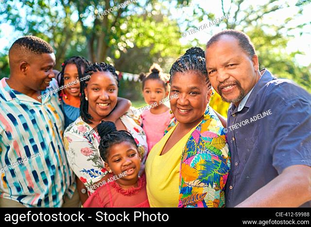 Portrait happy multigenerational family in summer park