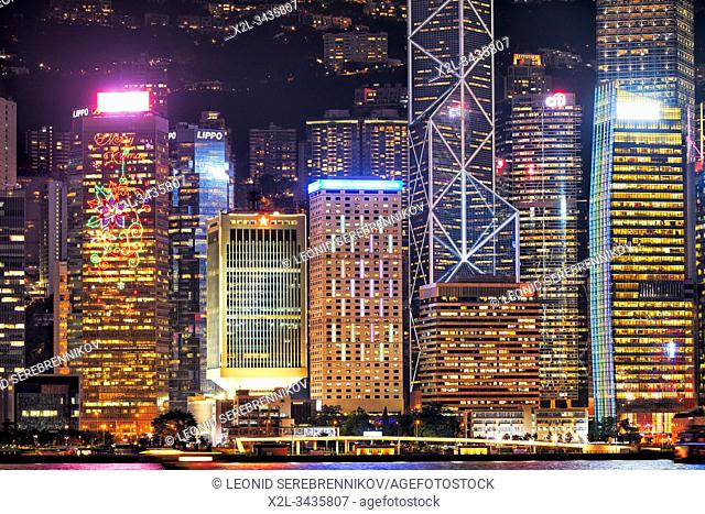 Central Waterfront buildings illuminated at night. Hong Kong, China