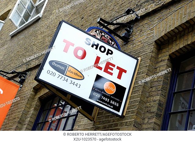 'Shop to Let' sign outside converted UK warehouse building