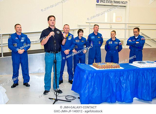 Crew instructor Josh Matthew speaks to a crowd during an Expedition 4243 cake-cutting ceremony in the Jake Garn Simulation and Training Facility at NASA's...