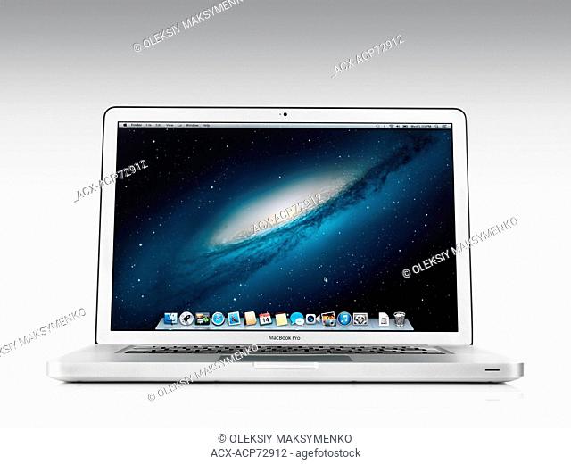 Apple Macbook Pro laptop computer front view with desktop on its display isolated on white background with clipping path