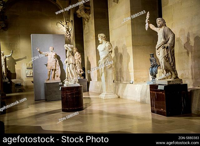 PARIS - JULY 22: Ancient statues at the Louvre, on July 22, 2012 in Louvre Museum, Paris, France. With 8, 5m annual visitors