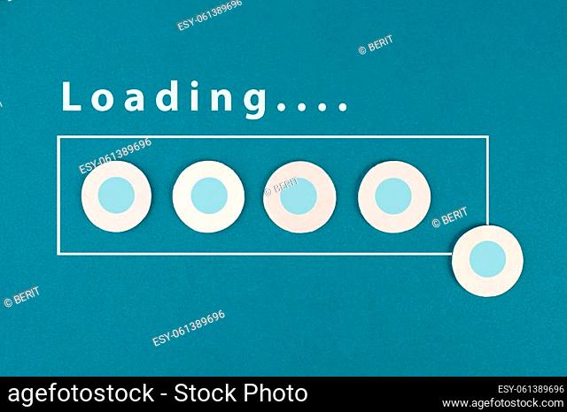 The word loading is standing over the progress bar, hand puts last cube to the row, business, education and marketing concept download a new program