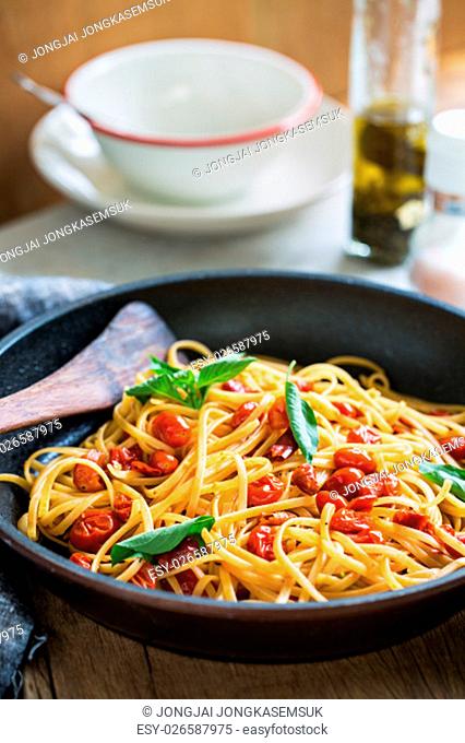 Freshly cooked Fettuccine with cherry tomatoes in a sauce pan