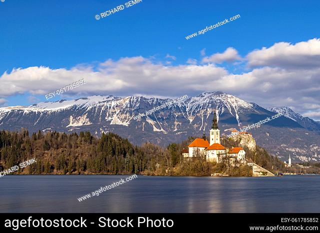 Bled lake with Bled catle, church and winter Julian Alps at background