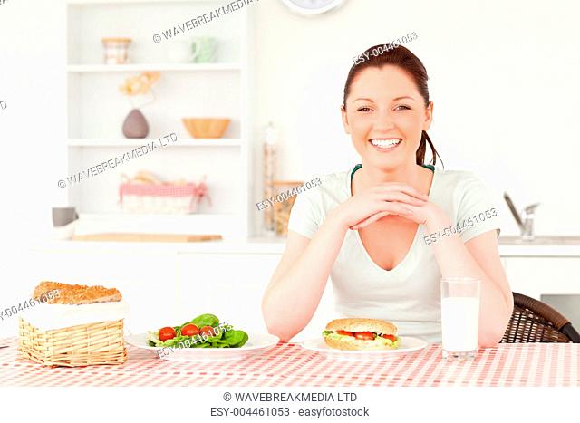 Good looking woman ready to eat a sandwich for lunch