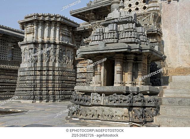 Small towers and ornate reliefs on walls near eastern entrance of Hoysaleshvara Temple, Halebid, Karnataka, india, View from North East