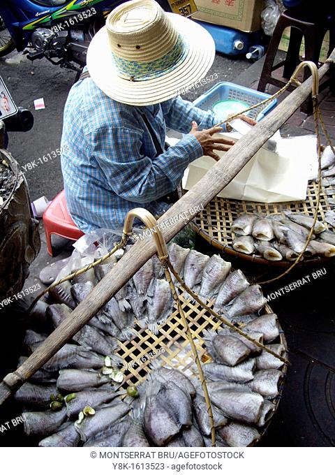 Fish seller with straw hat in Hua Hin street market, Thailand