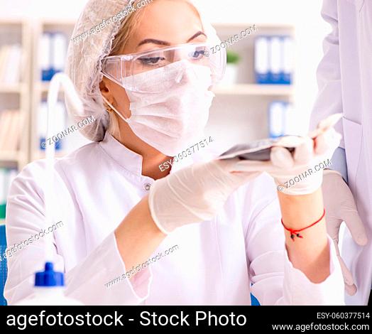 The young female woman doctor in hospital clinic lab
