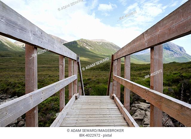 Wooden bridge over Allt Dearg Mor with a view towards Glen Sligachan, Isle of Skye, Scotland, United Kingdom