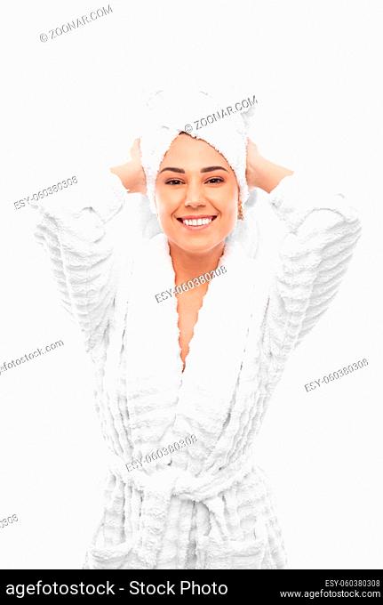 Young woman in a bathrobe and towel on her head, spa and care portrait, clean natural face, portrait on a white background isolated. Studio shot