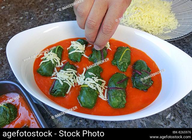 Swabian cuisine, preparing Bietigheim leaf frogs in paprika sauce, sauce, stuffed chard leaves in paprika sauce are sprinkled with cheese, grated hard cheese