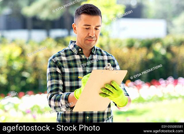 man with clipboard at summer garden