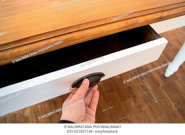 Hand open drawer box of wooden table, stock photo