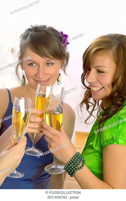 Young women clinking glasses of champagne